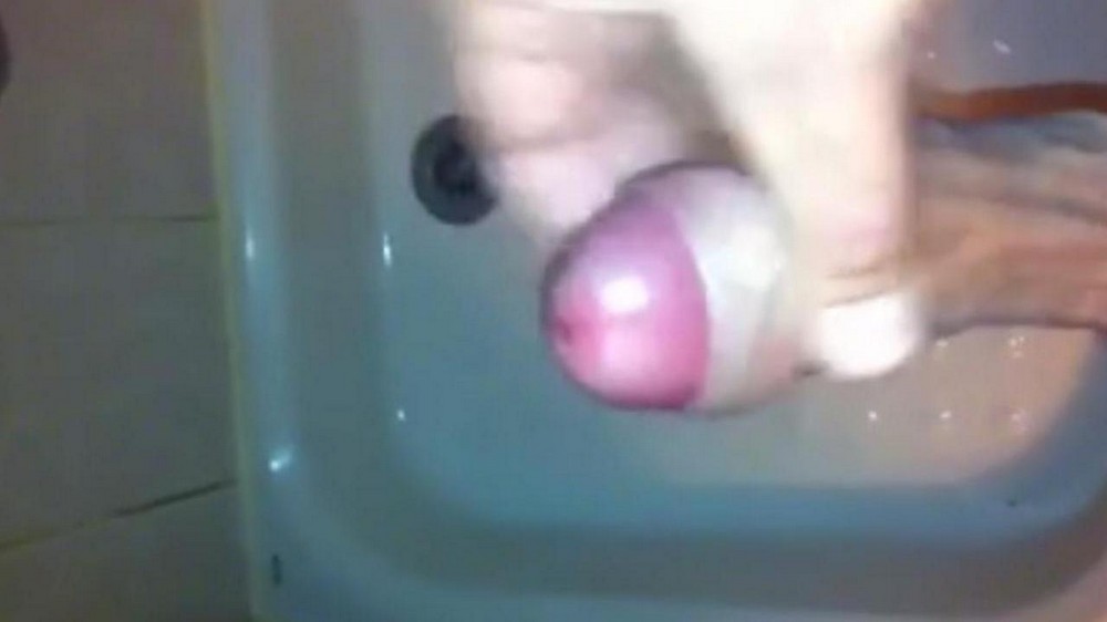 The boy stands in the shower and jerks off his penis with his hand, extracting cum - porn video  